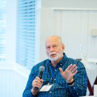 man asks question during panel